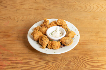 Marinated dogfish fritters battered in wheat flour and eggs with aioli sauce for dipping