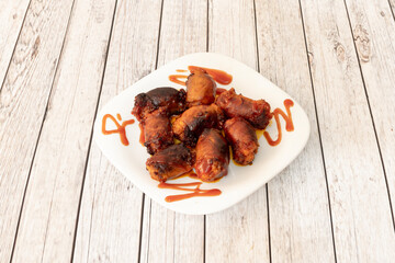 Charcoal-grilled cantimpalos chorizos on white plate