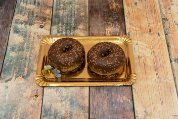 delicious chocolate donuts with on golden tray