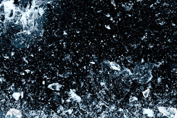 Crushed ice natural black background pattern.
