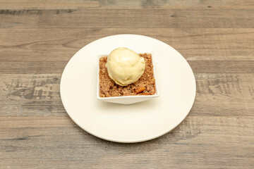Sweet corn popcorn dessert with cookie pieces and vanilla ice cream scoop on white tableware