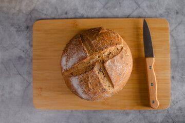 loaf of bread and a knife on cutting board flat lay