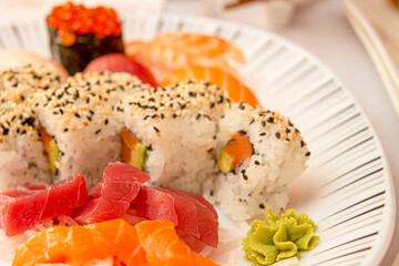 Sashimi sushi of red tuna and smoked Norwegian salmon with wasabi and Japanese rice with vinegar and sesame and poppy seeds
