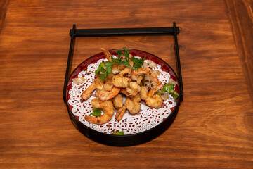 Japanese recipe of tempura prawns fried in olive oil with peppercorns, onion and green peppers
