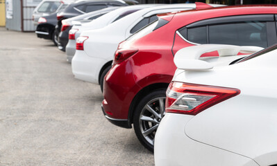 White car parked neatly inside an outdoor parking lot.