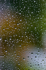 Water drops on the transparent glass of the window. Rain background, wallpaper. Macro.