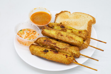 Thai Chicken Satay Skewers with Bread and Sauce on a White Plate