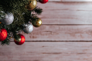 Christmas tree with decorative balls on wooden background. Copy space. Selective focus.