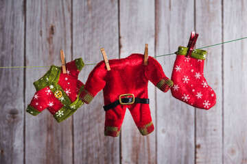 Christmas elf clothes hung with clothespins. Copy space. Selective focus.