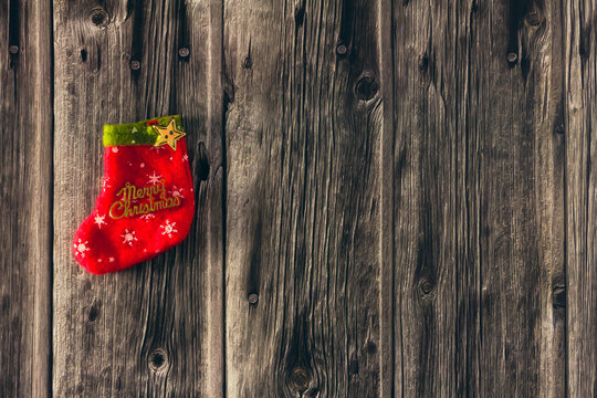 Decorative Christmas stocking on wooden background. Copy space. Selective focus.