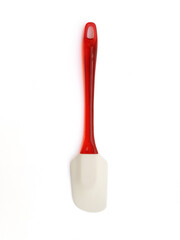 Aerial view of silicone spatula and red plastic handle isolated on white background. Close up of Non-stick rubber spatula for spreading, cooking, baking, mixing food. Cookware.