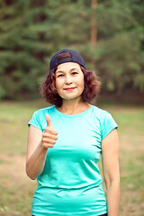 Senior middle age female woman running outdoors in a park
