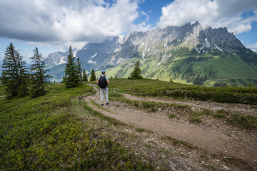 Fototapeta na wymiar Traveler man on hiking trail enjoying Wilder Kaiser mountains, Tirol - Austria
