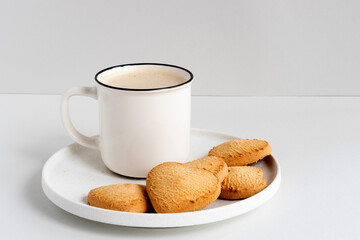 White mug with heart shaped cookies in a plate, closeup mockup