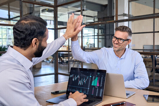 Two Happy Successful Excited Diverse Traders Investors Giving High Five Celebrating Successful Stock Exchange Trading Deal, Rising Crypto Bull Market Shares Growth, Ipo Profit Victory Concept.