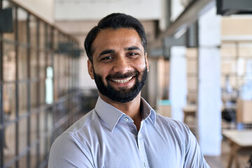 Happy smiling bearded indian business man small business owner, company leader or sales manager, male hispanic ceo executive, successful lawyer looking at camera standing in office, headshot portrait. - obrazy, fototapety, plakaty