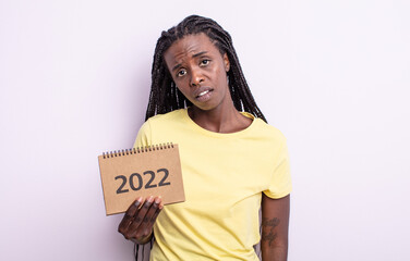 pretty black woman feeling puzzled and confused. 2022 calendar concept