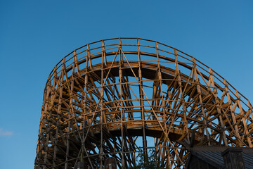 Curve of a large wooden roller coaster.