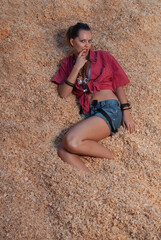 woman in the arena lying on the straw of the horses