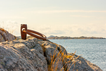 Fototapeta premium Old metal mooring ring on a cliff.