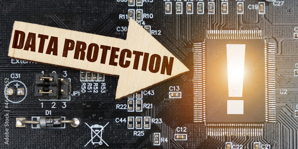 Poster On the computer board, a microcircuit with an exclamation mark and an arrow with the inscription - Data protection