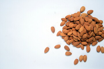 Fresh almonds in the wooden bowl, Organic almonds, almonds border white background, Almond nuts on a dark wooden background. Healthy snacks. Top view. Free space for text.