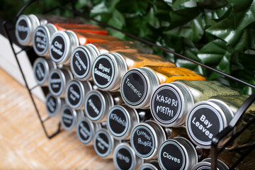 A view of a common labeled Indian spices on a rack.