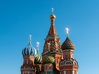 Fototapeta na wymiar Domes of St. Basil's Cathedral with golden crosses on a sunny day. Red Square, Moscow, Russia.