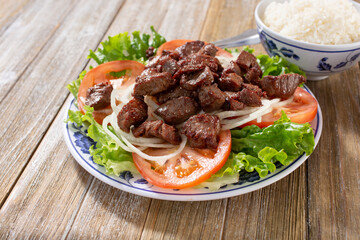 A view of a plate of shaking beef.