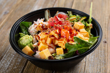 A view of a poke bowl, featuring ahi and tamagoyaki.