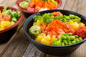 A view of three customized poke bowls. 