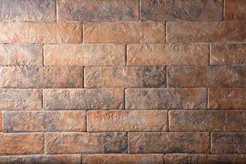 A view of a rustic countryside style retro brick wall facade, as a background.