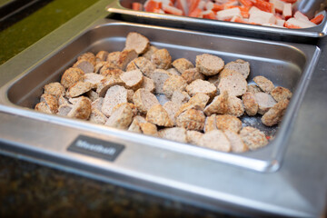 A view of a steamer tray filled with meatballs, seen at a local restaurant.