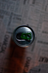 A dark photo of a 250ml beer can illuminated on the left by cold light and against warm light