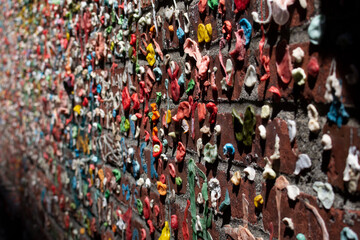 A view of an array of used chewing gum, pressed up against a brick wall, seen at the Seattle Gum Wall.
