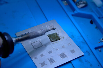The hands of cellphone technology device maintenance engineer (professional repairman) work on the...