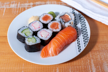 Close-up of a white plate with some sushis and a sashimis