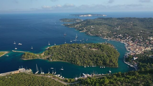 Aerial drone video of iconic port of Gaios a natural fjord bay ideal for safe anchorage in island of Paxos, Ionian, Greece