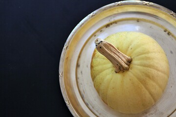 bright little pumpkin on a silver tray, creamy little pumpkin, whole pumpkin on a silver tray, autumn vegetable