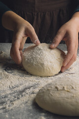 Closeup of women hands kneading dough