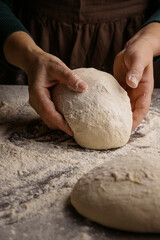 Closeup of women hands kneading dough