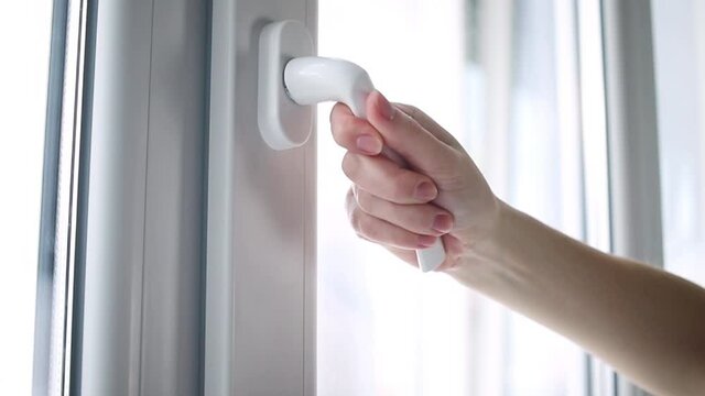 Hand closing the home window close-up view slow motion footage