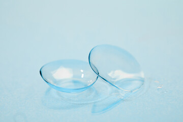 contact lenses on blue background close up view   - Image