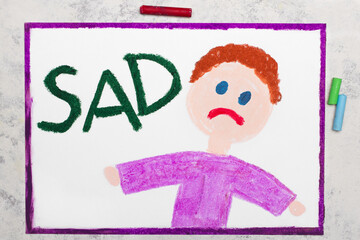 Colorful drawing: Sad boy and word SAD