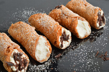 Homemade sicilian cannoli with ricotta and chocolate chips. Shallow DOF.