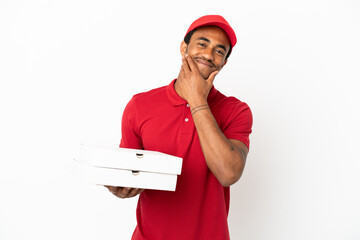 African American pizza delivery man picking up pizza boxes over isolated white wall happy and...