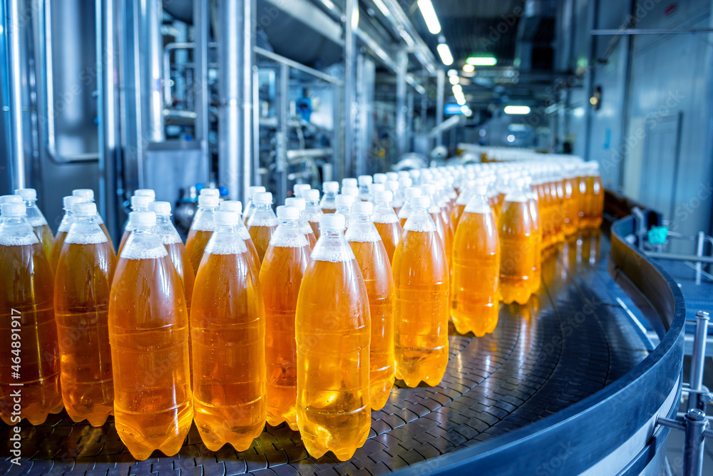 Wall mural conveyor belt with bottles for juice or water at a modern beverage plant