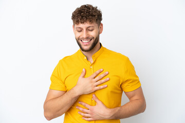 Young handsome caucasian man isolated on white background smiling a lot