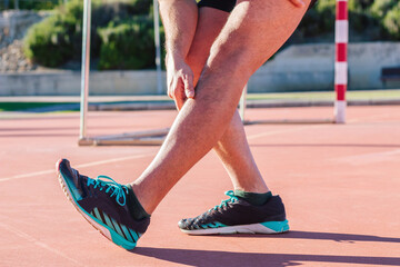 Legs of an athlete and runner, stretching and warming up legs, hamstrings and quads before starting their outdoor training and marathon.