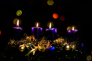 four blue burning candles on advent wreath, dramatic and contract, christmas concept